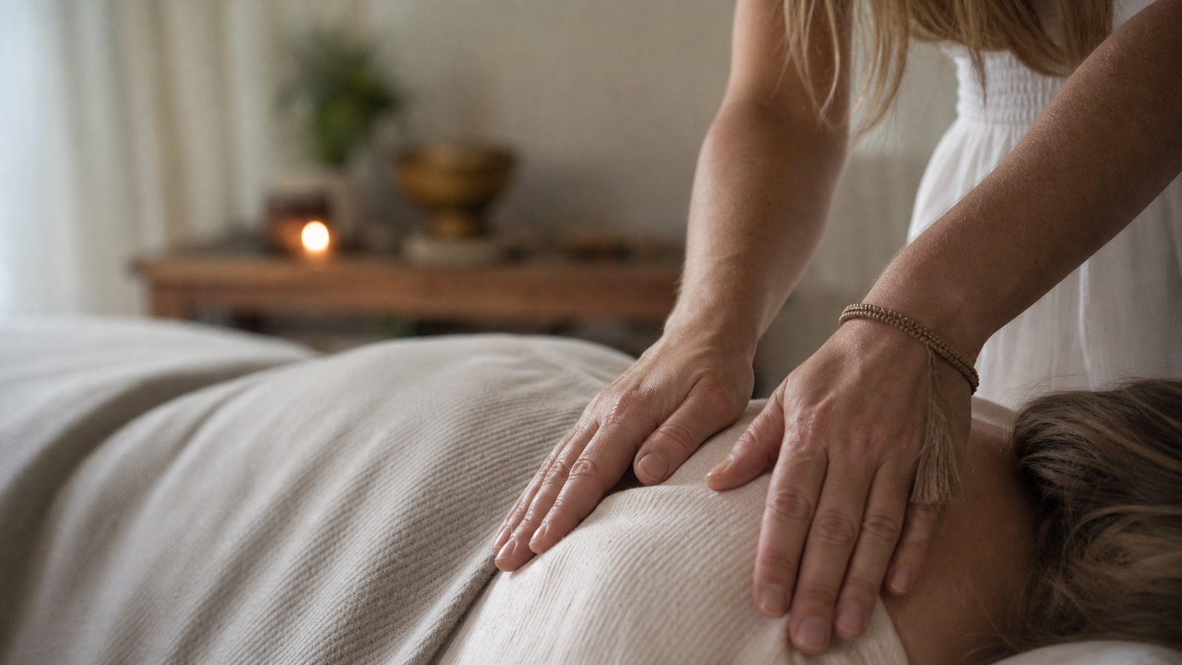 Amanda's hands offering Reiki support to a client